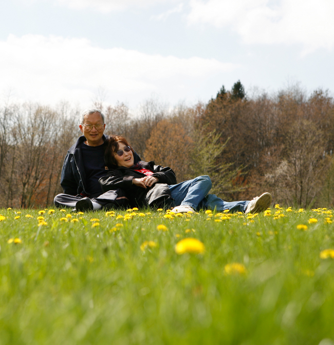 Dad and Mom resting in a grassy field of flowers